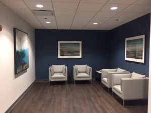 Custom Framed Artwork installed for Wintrust in Milwaukee with blue and white wall