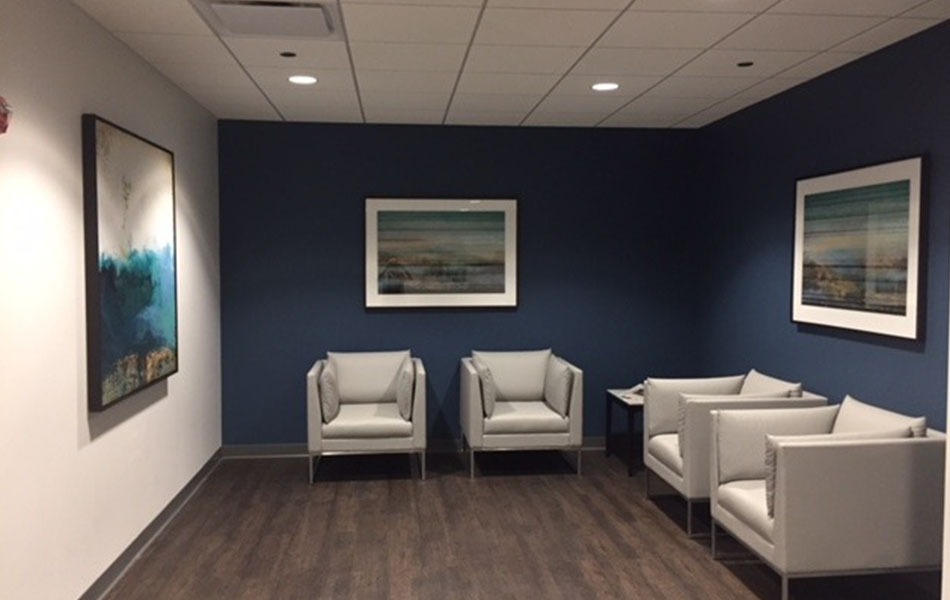 Custom Framed Artwork installed for Wintrust in Milwaukee with blue and white wall