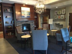 Custom Framed Artwork installed for Hospice Inpatient Center in the fireplace area