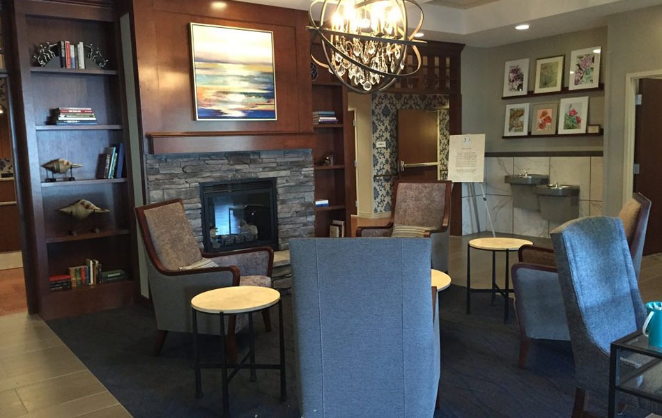 Custom Framed Artwork installed for Hospice Inpatient Center in the fireplace area