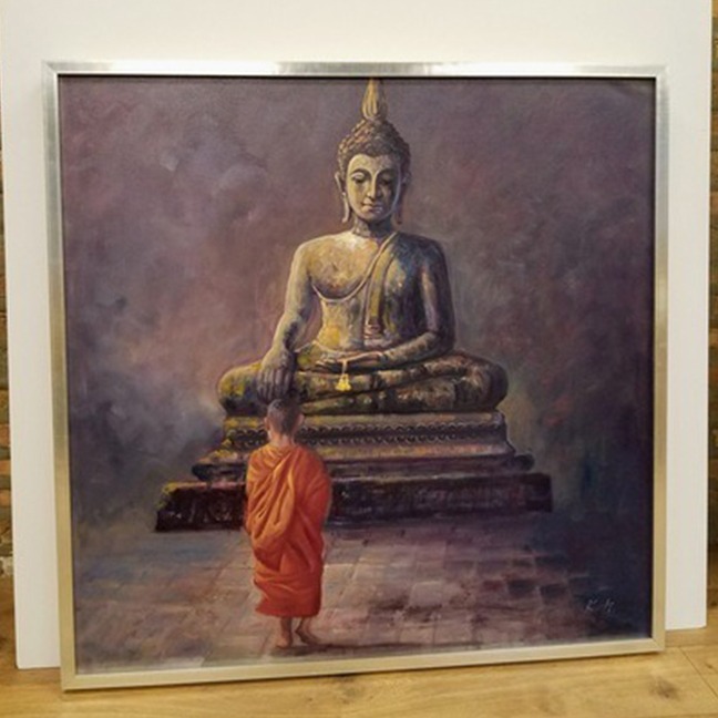 custom framed artwork with a silver frame of a child monk and buddha