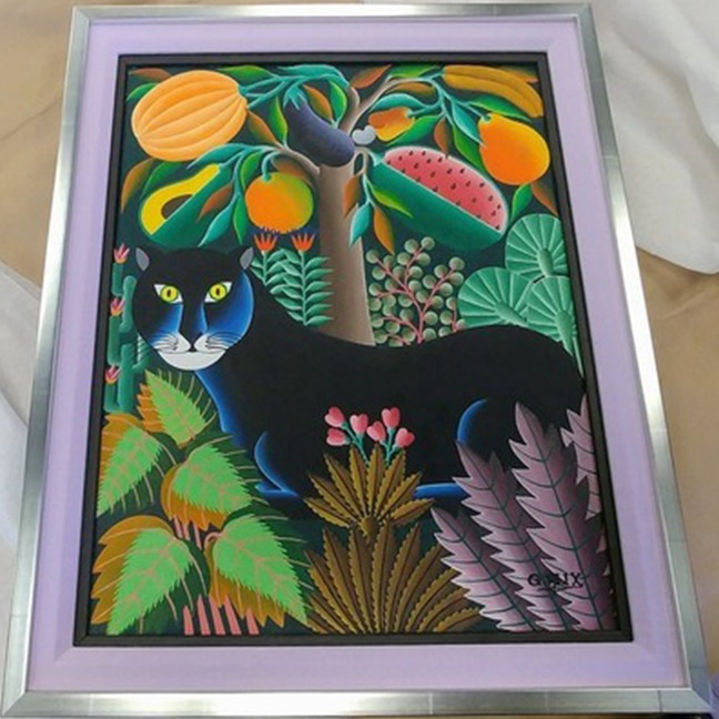 custom framed artwork on a silver frame with a black panther and colorful surrounding